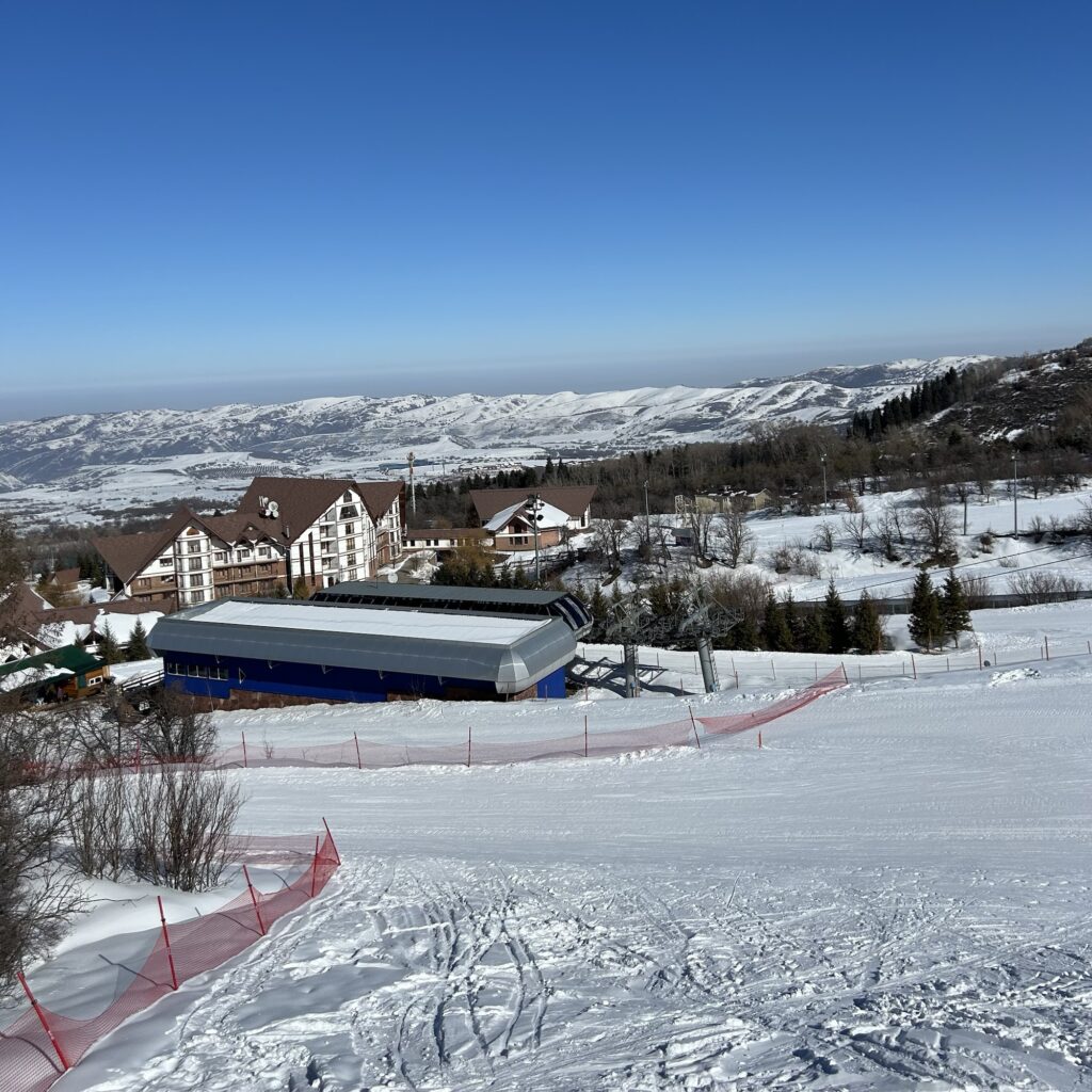 Ak Bulak ski resort, seen from the chair lift, with the very cool and unique looking Ak Bulak Hotel in the background