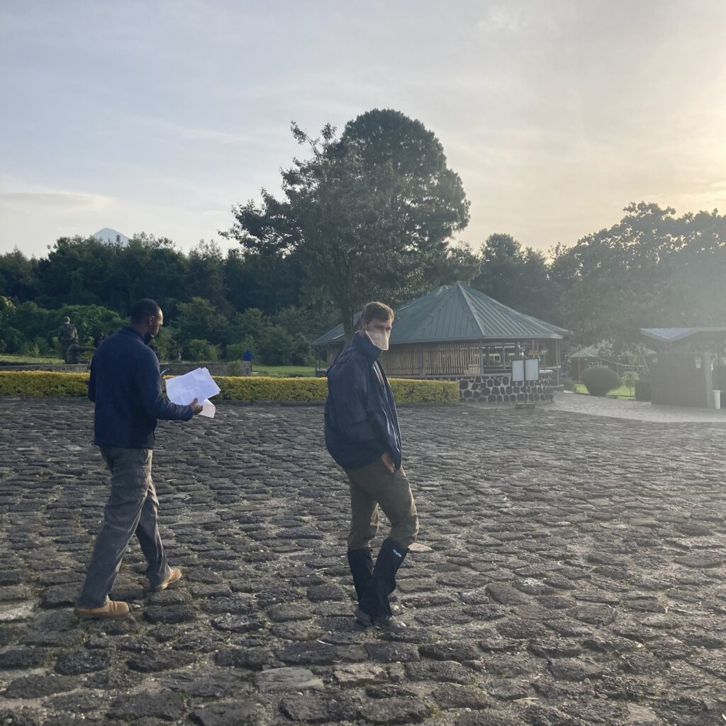 A man stands in the parking lot of Volcanos National Park Headquarters, prior to embarking on a Gorilla Trek