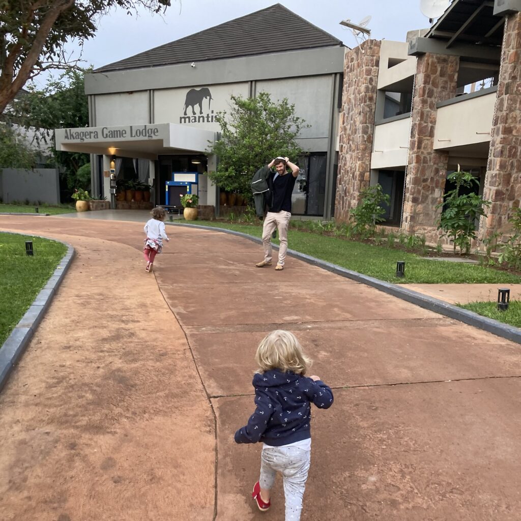 children run towards Mantis Lodge at Akagera Safari Park