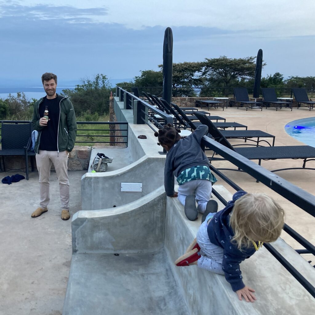 children play around a pool area at a hotel in Akagera Safari Park