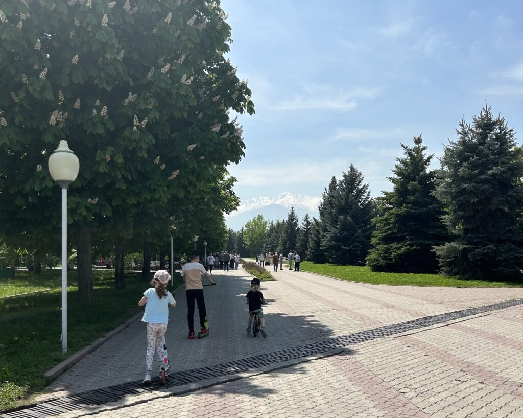 A girl rides her scooter in First President's Park, Almaty