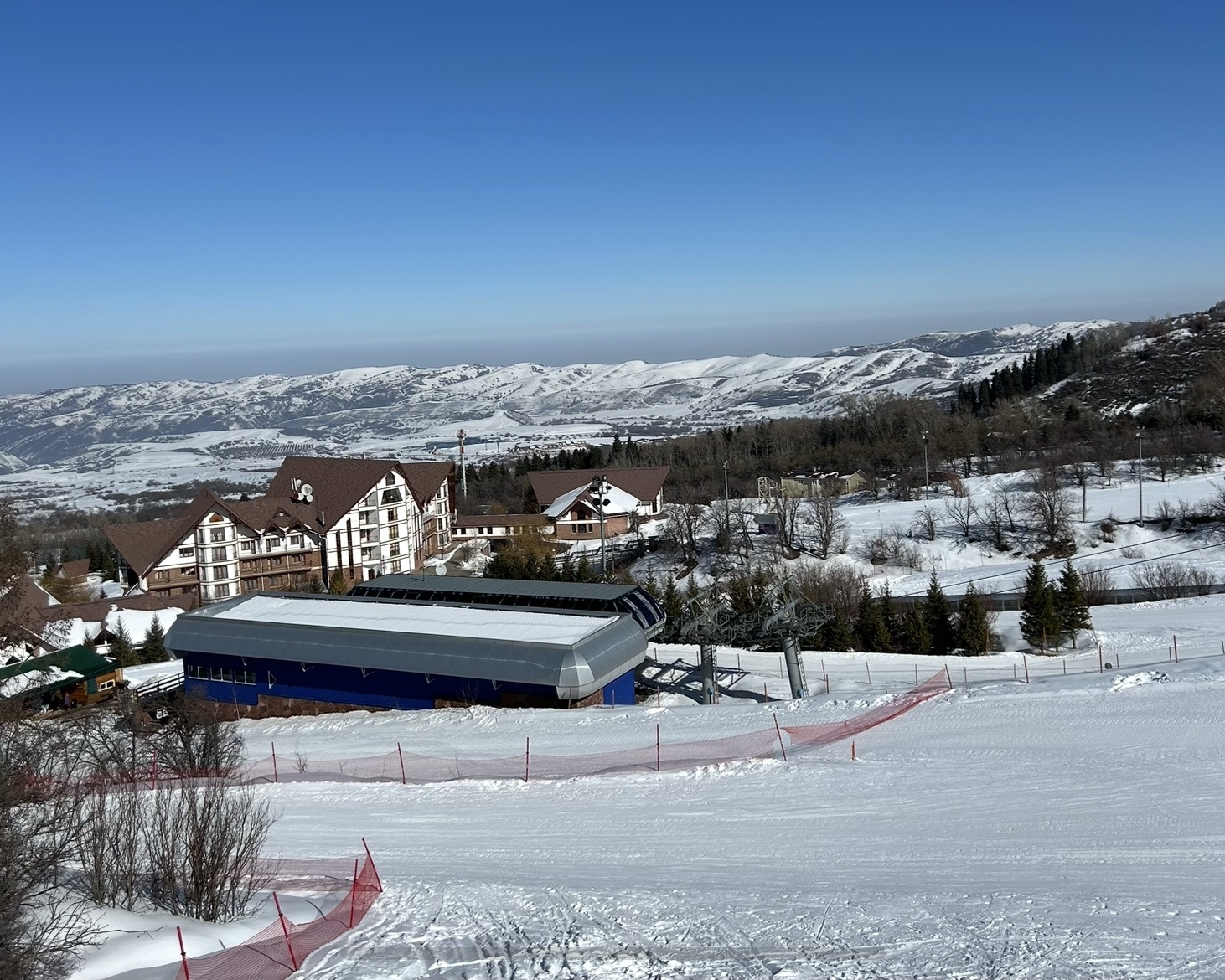 Ak Bulak Hotel sits in the background behind the chairlift station with snowy slopes in the foreground