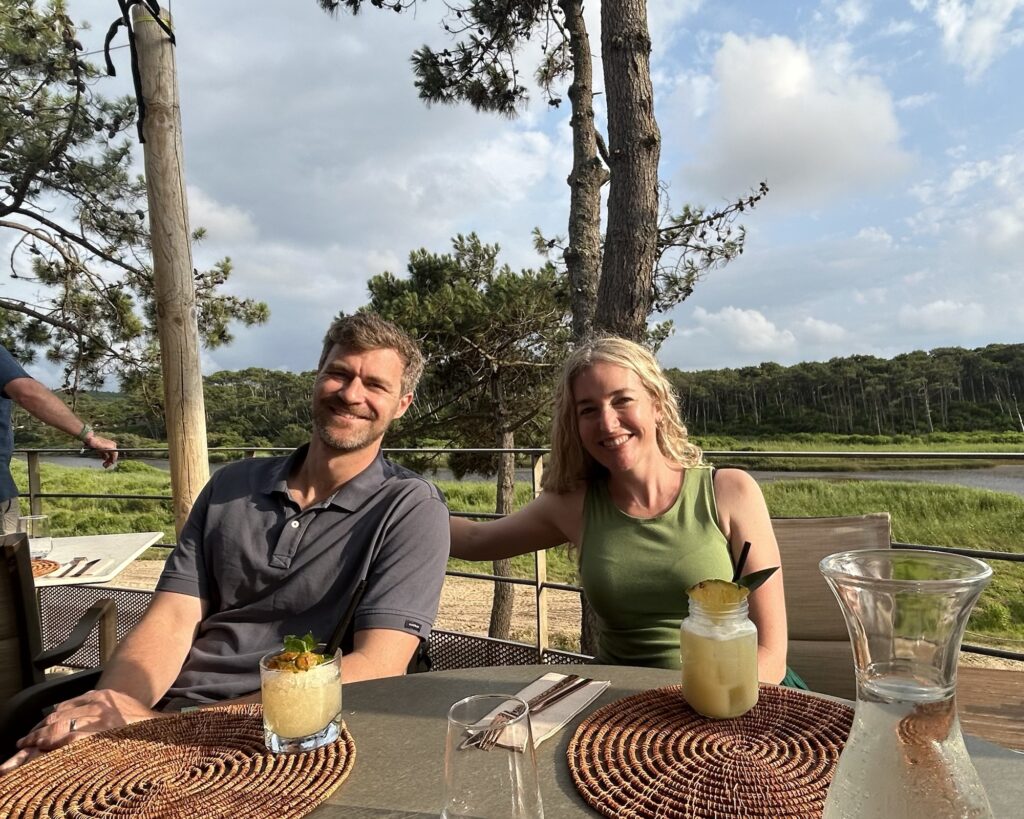 A photo of a man and a woman at a table overlooking a river behind them