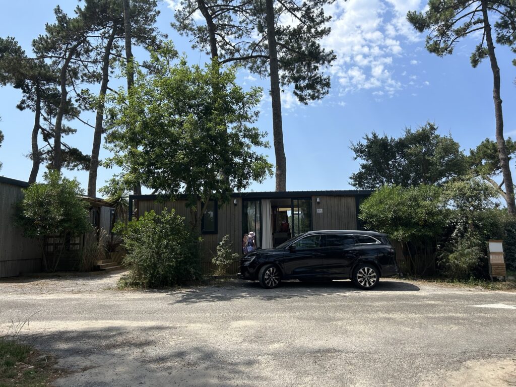 A photo of a cabin with a car parked out front