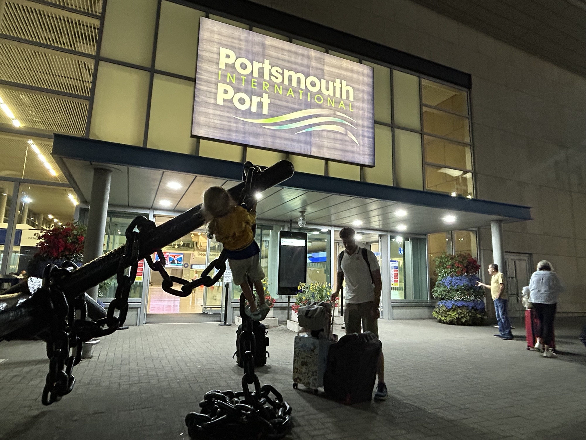 A child plays on a statue in front of the Portsmouth to Caen ferry terminal