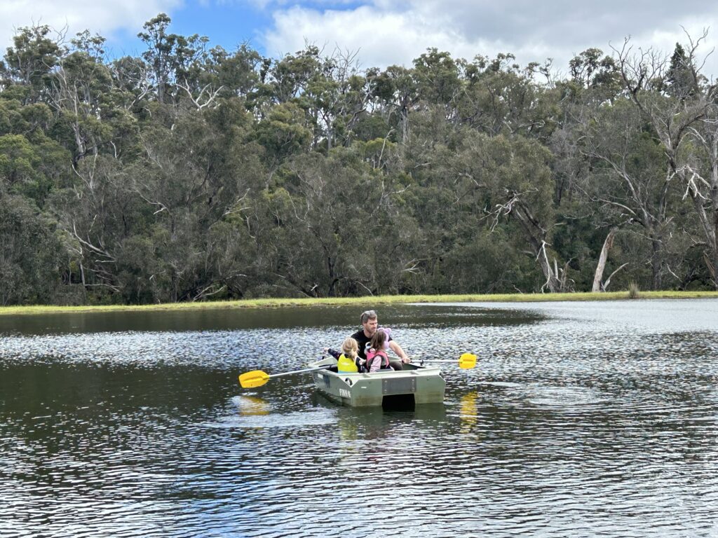 A photo of a man with 2 children in a boat on a lake at Clover Cottage Manjimup