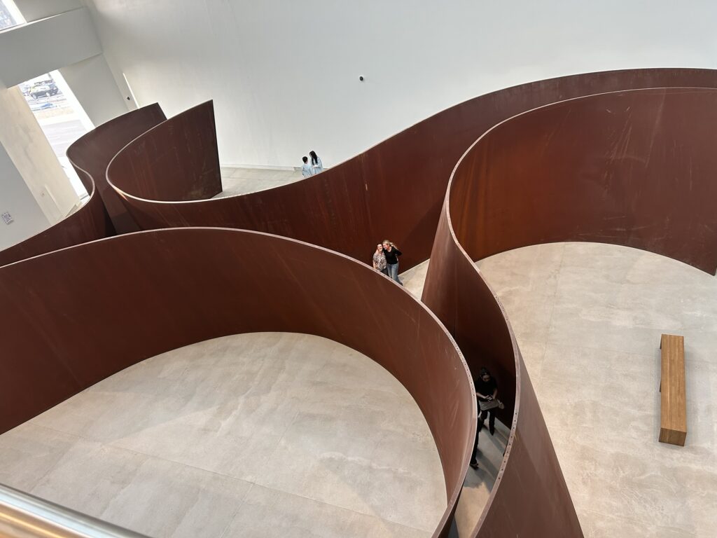 A photo of 2 women in the middle of a large metal sculpture at Almaty Museum of Arts
