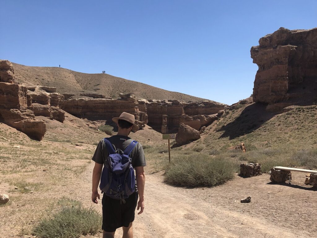 A photo of a man walking through Charyn Canyon, Kazakhstan